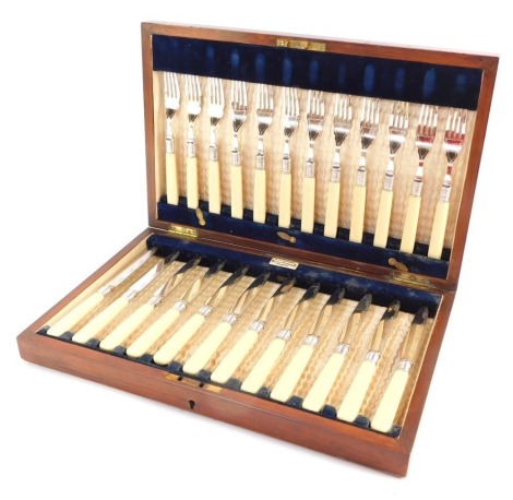 An early 20thC W F Johnson of Leicester bone handled and silver plated cutlery set, comprising twelve fish knives and forks, in an oak fitted case.