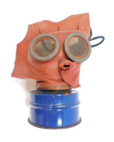 A child's gas mask, with red top and blue cylinder. (AF)