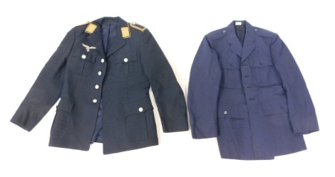 A Luftwaffe jacket, bearing WWII period badges, and a US military jacket. (2)