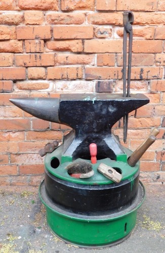 A iron anvil, on adapted home made stand, formed of two tyre inners, with tool sections and small quantity of tools.