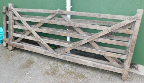 A pair of wooden swing garden five bar gates, each gate 305cm wide, 132cm high.