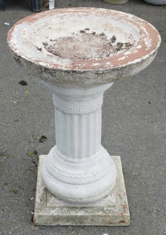 A reconstituted stone bird bath, on Corinthian column support and a matched square base, 65cm high, 45cm diameter.