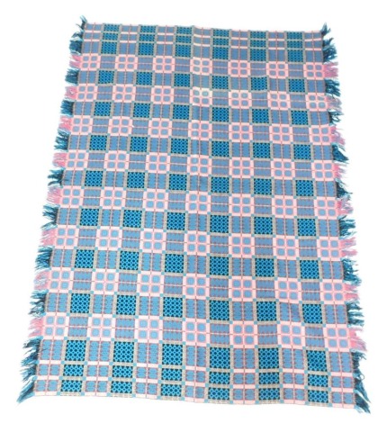 A Welsh blanket, in turquoise pink and black, with tassel ends, 240cm x 200cm.