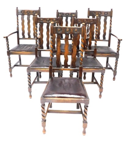 A set of six oak dining chairs, each with a carved finial back, on barley twist column supports, with drop in leatherette seats, to include two carvers.