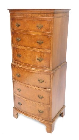 A burr walnut tallboy, with arrangement of three drawers in two parts, with brass handles and bracket feet, 132cm high, 54cm wide, 42cm deep.