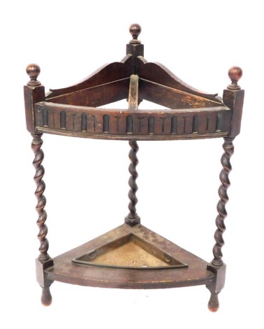 An early 20thC mahogany corner stick stand, with two section support, with metal drip tray, 76cm high.