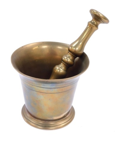 A brass pestle and mortar, 10cm high.