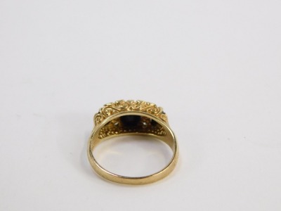 A 9ct gold gypsy ring, set with three dark blue stones and four CZ, size O½, 3.7g all in, boxed. - 2