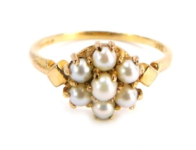 A 9ct gold cultured pearl cluster ring, the cluster set with six cultured pearls with diamond shaped shoulders, on a plain band, size P, 1.8g all in.