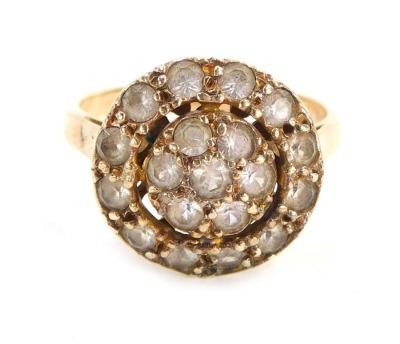 A dress ring, the circular two layered cluster set with CZs on a raised basket, yellow metal stamped 9ct, size M, 4.3g all in.