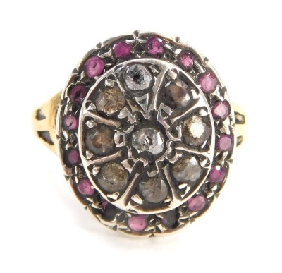 An 18ct gold dress ring, the large oval centre set with various rubies and diamonds, with etched design V splayed shoulders and later matched ring head, ring size Q½, 4.3g all in, boxed.