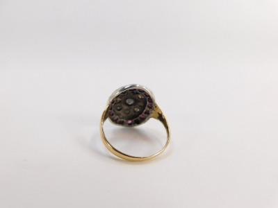 An 18ct gold dress ring, the large oval centre set with various rubies and diamonds, with etched design V splayed shoulders and later matched ring head, ring size Q½, 4.3g all in, boxed. - 2