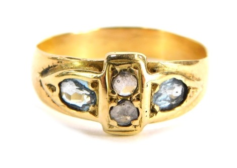 An 18ct gold aquamarine and diamond dress ring, the central band set with two diamonds with two oval cut aquamarines to each shoulder, yellow metal stamped 18c, ring size O½, 2.9g all in.