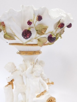 A Victorian Moore Brothers porcelain comport, the flared bowl with applied blackberry detail, on a tripod base, with three cherubs, with gilt detailing, unmarked, 30cm high. - 3