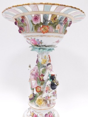 A Dresden porcelain centrepiece, the elaborately decorated fluted and pierced top in pink and turquoise with gilt detail, applied flowers and figure of lady and gentleman to stem, on scroll feet, 42cm high. - 3