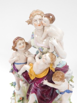 A Capodimonte porcelain figure group of mother and four children, on a circular foot, with four scroll feet, 41cm high. - 2