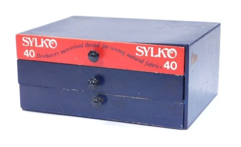 A Sylko advertising thread case, with three drawers painted in blue and red, with ebonised handles, 14cm high, 31cm wide, 22cm deep.