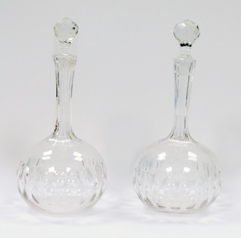 A pair of late 19thC balloon decanters, each with a faceted stopper, on plain design stem with cut oval body, 25cm high.