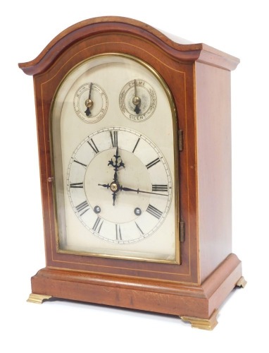 A late 19thC mahogany cased mantel clock, with arch top dial and silvered numeric chapter ring, the twenty one day movement with chiming mechanism, terminating in brass bracket feet, 35cm high, 25cm wide, 17cm deep.