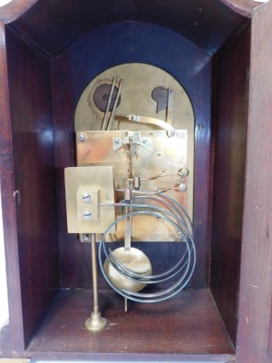 A late 19thC mahogany cased mantel clock, with arch top dial and silvered numeric chapter ring, the twenty one day movement with chiming mechanism, terminating in brass bracket feet, 35cm high, 25cm wide, 17cm deep. - 5