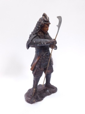 A bronze figure of a warrior, in Eastern design, with layered armour and weapon, 43cm high. - 2