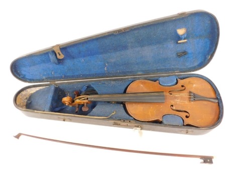 A violin, possibly German with a two piece back and a bow in an ebonised case. (AF)