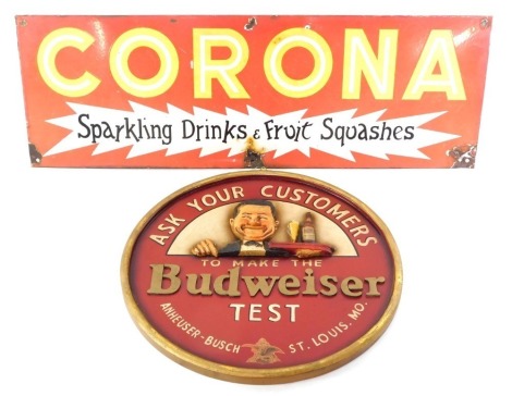 A Budweiser advertising crest, inscribed 'Ask your customers to make the Budweiser test', red ground with gold painted border, 40cm diameter, and a Corona Sparkling Drinks and Fruit Squashes red enamel advertising sign, 25cm x 66cm. (2)