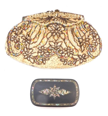 An Edwardian beaded evening purse, 21cm diameter, and a Victorian black and ebonised papier mache trinket box, 10cm wide. (2, AF)