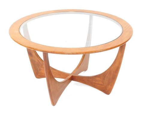 A G-Plan style circular teak coffee table, with glass inset, cross section base, 84cm diameter, 46cm high.