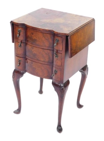 A walnut side table, with two drop leaves and a shaped front above three drawers with drop handles, with shell capped cabriole legs, 68cm high, 41cm wide, 38cm deep.