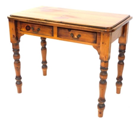 A pine side table, with moulded cornice, above two drawers, on bobbin turned legs, 75cm high, 97cm wide, 53cm deep.