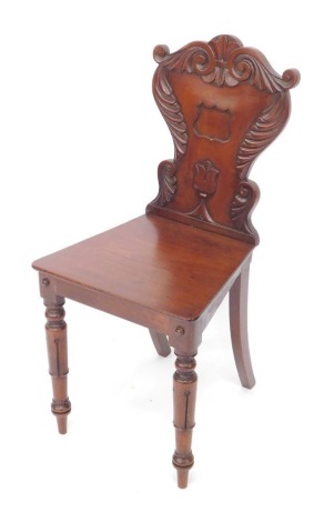 A 19thC mahogany hall chair, with shaped shield back, on carved legs, the seat 35cm deep.