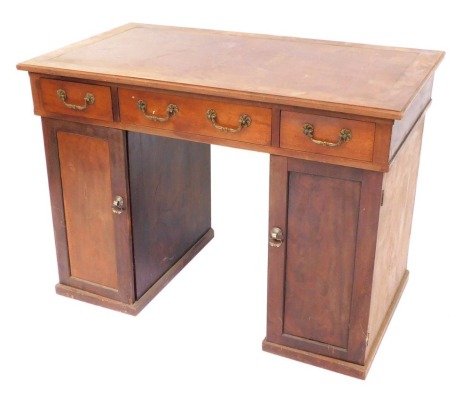 A mahogany pedestal desk, the brown leatherette inset top, above three drawers and two cupboards, 78cm high, 108cm wide, 62cm deep.