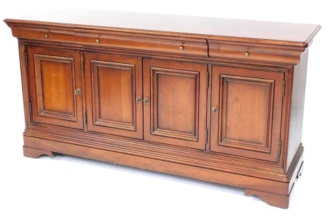 A continental cherrywood sideboard, with canted front above arrangement of one long and two short drawers, above four cupboard doors, terminating in bracket feet, 87cm high, 172cm wide, 51cm deep.