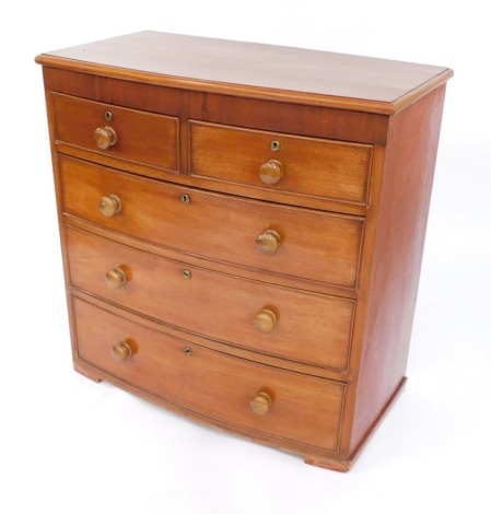 A Victorian bowfront mahogany chest, of two short and three long drawers, with turned handles with brass escutcheons, lacking feet, 95cm high, 92cm wide, 51cm deep.