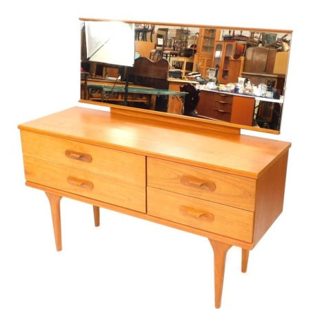 A 1960's teak effect dressing table, with large rectangular mirrored back, above four drawer section on tapered legs, 121cm high, 126cm wide, 44cm deep.