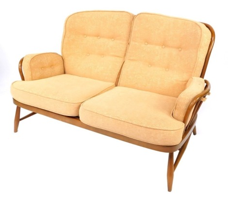 An Ercol two seater sofa, the light elm back, with terracotta coloured cushion seat, 90cm high, 136cm wide, 63cm deep. The upholstery in this lot does not comply with the 1988 (Fire & Fire Furnishing) Regulations, unless sold to a known exporter or uphols