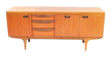 A teak sideboard, with three cupboard doors and three drawers, each with moulded handles, on tapered supports, 77cm high, 176cm wide, 45cm deep.