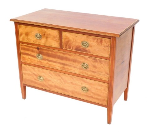 An Edwardian mahogany chest of two short and two long drawers, with satinwood crossbanding to top and drawer surrounds, with brass oval escutcheons, on tapered legs, 73cm high, 92cm wide, 49cm deep.