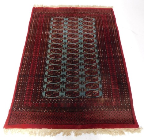 An Afghan rug, on a red and blue ground, with medallion central panel, on cream tassel ends, 197cm x 124cm.