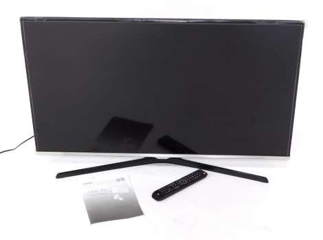 A Samsung 39" smart TV, model UE40J5100AK, with instruction manual and remote control.