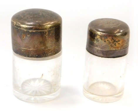 A Victorian cut glass smelling salts jar, with stopper, the silver mount and hinged lid monogram engraved, George Heath, London 1898, and a further jar, stopper lacking, with silver and a hinged lid, John Grinsell & Sons, Birmingham 1890. (2)