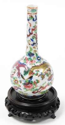 A Chinese Canton porcelain bottle vase, decorated with dragons chasing the flaming pearl together with flowers and butterflies, on a pierced hardwood base, the vase 18cm high. - 3