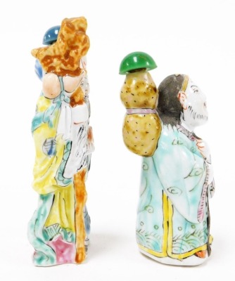 A Chinese pottery figure of a sage, carrying yoke bearing a coin and a flowering peach, 15cm high, and two porcelain figural snuff bottles, 9cm and 8cm high. - 5