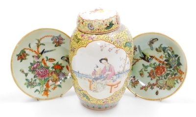 A Chinese famille jaune jar and cover, the front and back panels decorated with figures in a garden, four character stencilled read Qianling seal to underside, 21cm high, and two celadon ground Canton dishes, decorated with birds and flowers, 15cm diamete