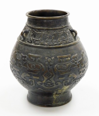 A bulbous Chinese bronze vase, on flared foot, the body cast with archaistic reliefs of animals below lug handles and frieze with inscription, the base with six character mark, 19cm high. - 3