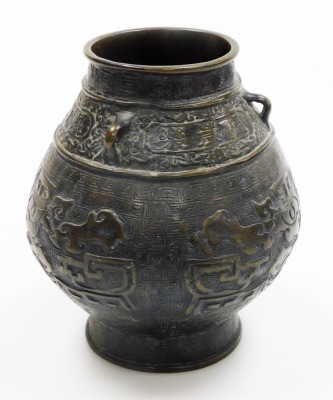 A bulbous Chinese bronze vase, on flared foot, the body cast with archaistic reliefs of animals below lug handles and frieze with inscription, the base with six character mark, 19cm high. - 4