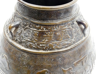 A bulbous Chinese bronze vase, on flared foot, the body cast with archaistic reliefs of animals below lug handles and frieze with inscription, the base with six character mark, 19cm high. - 8