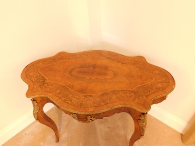 A 19thC kingwood walnut and rosewood marquetry topped serpentine centre table, with gilt metal mounts, 74cm high, 121cm wide, 76cm deep. - 10