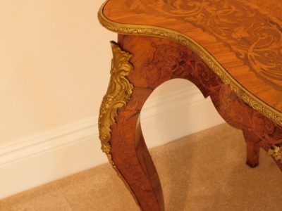 A 19thC kingwood walnut and rosewood marquetry topped serpentine centre table, with gilt metal mounts, 74cm high, 121cm wide, 76cm deep. - 11